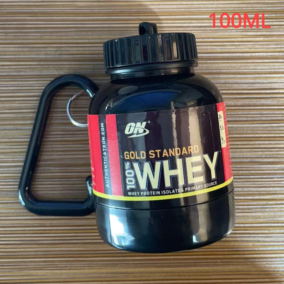 Portable Protein Powder Bottle with keychain attachment, built-in funnel, and medicine box, designed for storing and mixing protein powder and supplements, ideal for camping and outdoor activities. 