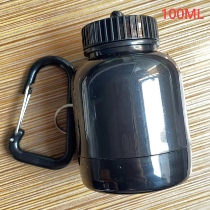 Portable Protein Powder Bottle with keychain attachment, built-in funnel, and medicine box, designed for storing and mixing protein powder and supplements, ideal for camping and outdoor activities. 