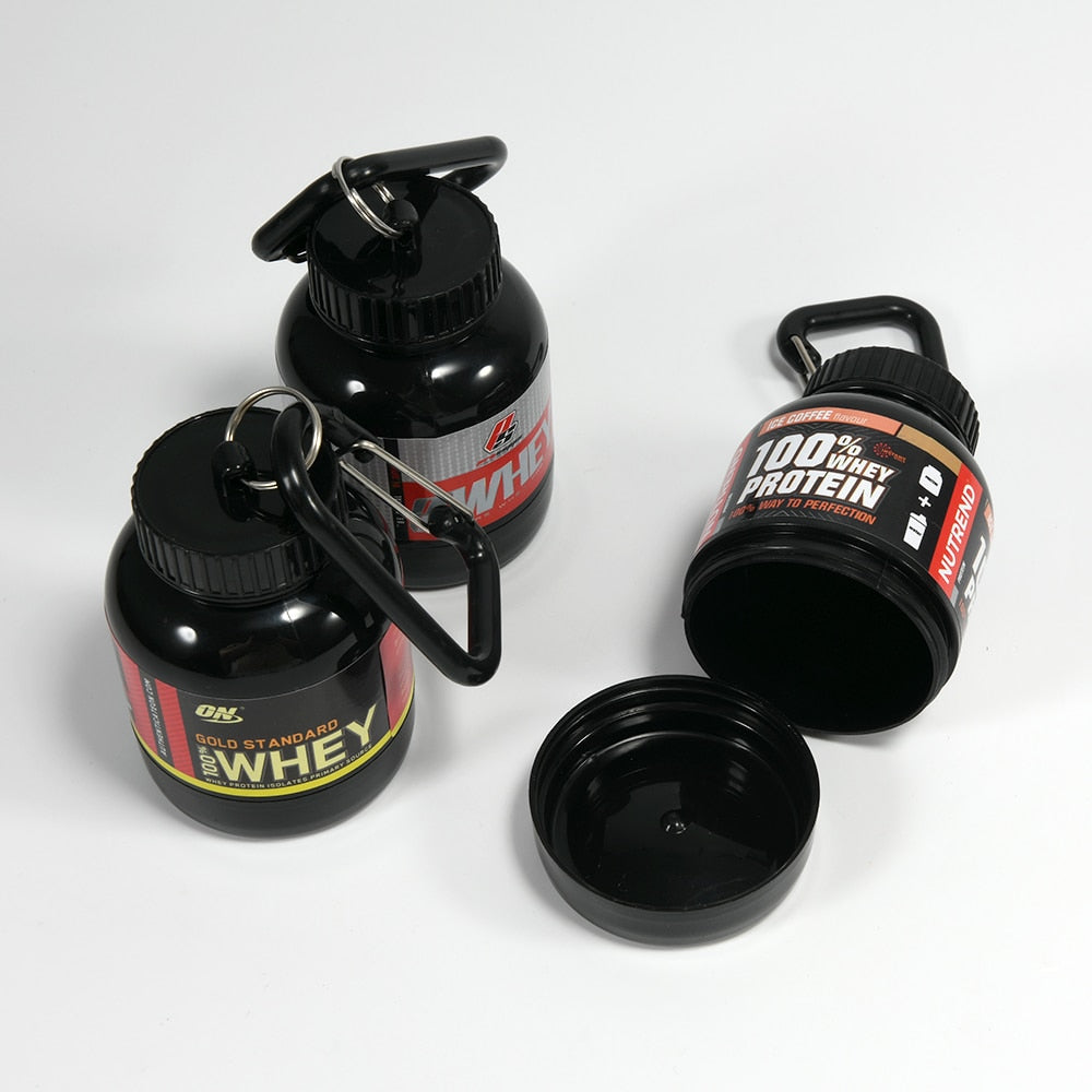 Portable Protein Powder Bottle with keychain attachment, built-in funnel, and medicine box, designed for storing and mixing protein powder and supplements, ideal for camping and outdoor activities. 