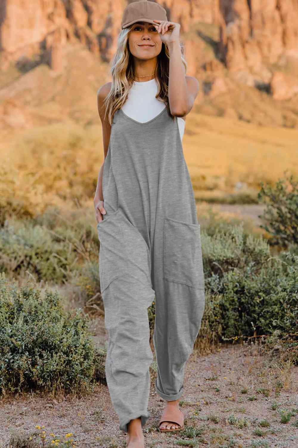 Double Take V-Neck Sleeveless Jumpsuit with Pocket – a blend of effortless elegance and modern chic. Made from luxurious, breathable fabric, it features a flattering V-neckline and a tailored silhouette that beautifully accentuates your figure.