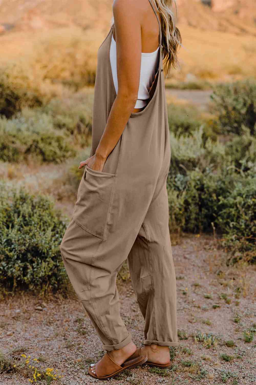 Double Take V-Neck Sleeveless Jumpsuit with Pocket – a blend of effortless elegance and modern chic. Made from luxurious, breathable fabric, it features a flattering V-neckline and a tailored silhouette that beautifully accentuates your figure.