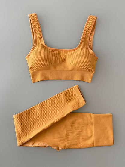 Two-piece Yoga Clothing Set with high-waisted, seamless leggings and a versatile, airy top for comfort and style during any workout.