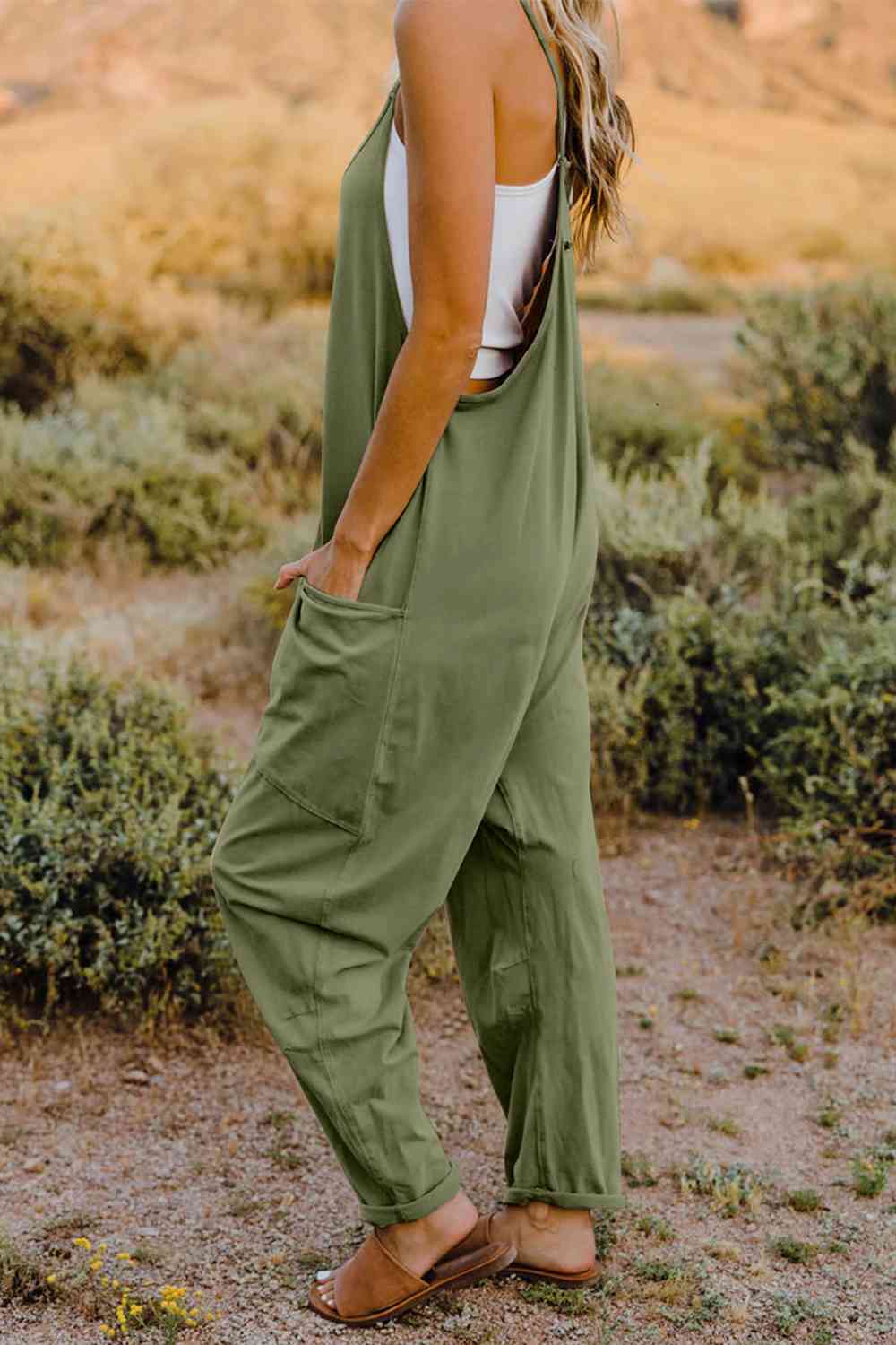 Double Take V-Neck Sleeveless Jumpsuit with Pocket – a blend of effortless elegance and modern chic. Made from luxurious, breathable fabric, it features a flattering V-neckline and a tailored silhouette that beautifully accentuates your figure.