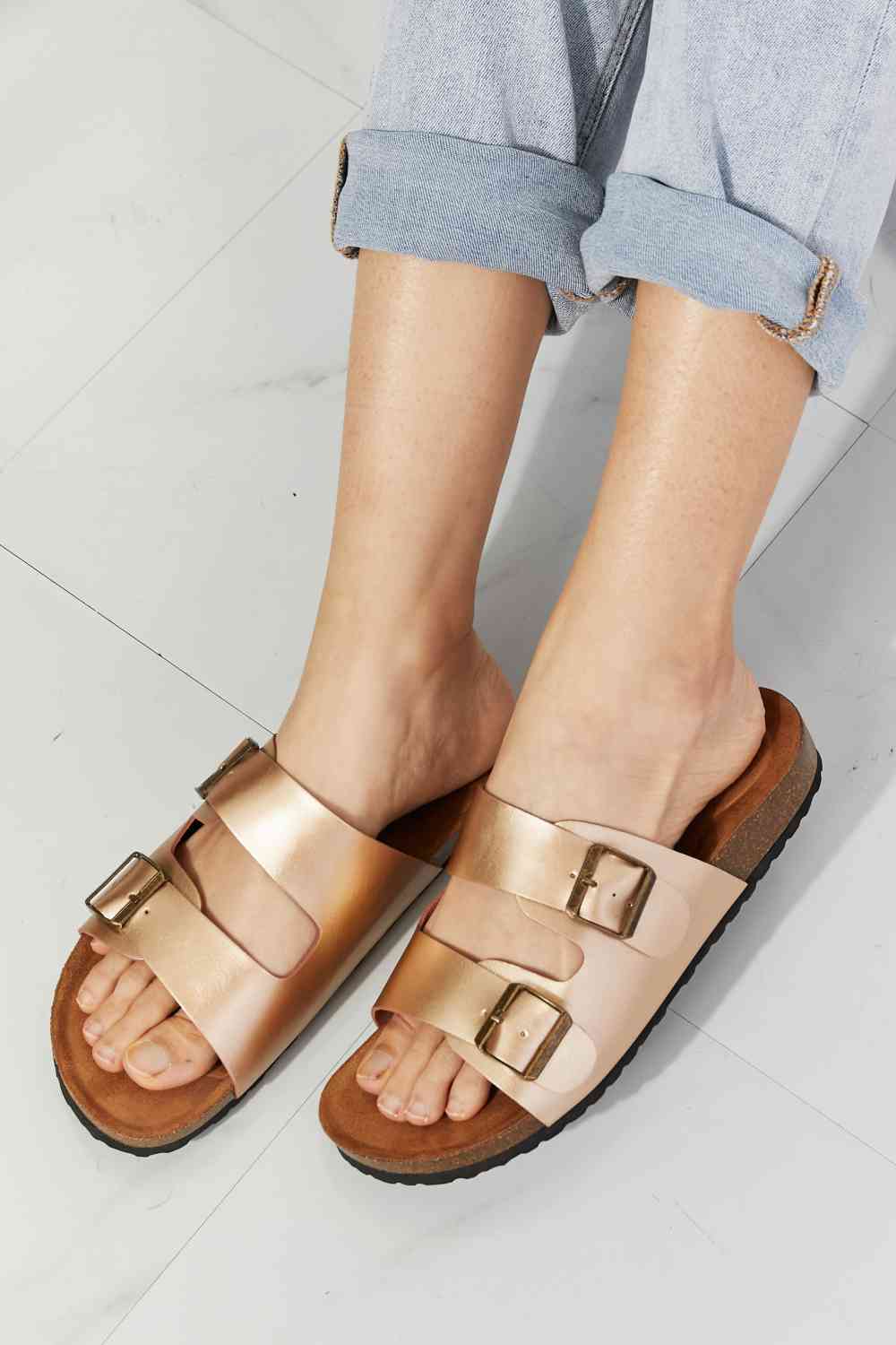 Double-banded slide sandals give a luxe look with their faux leather upper and cork sole. Their comfy design is perfect for wearing for almost any summer adventure. 