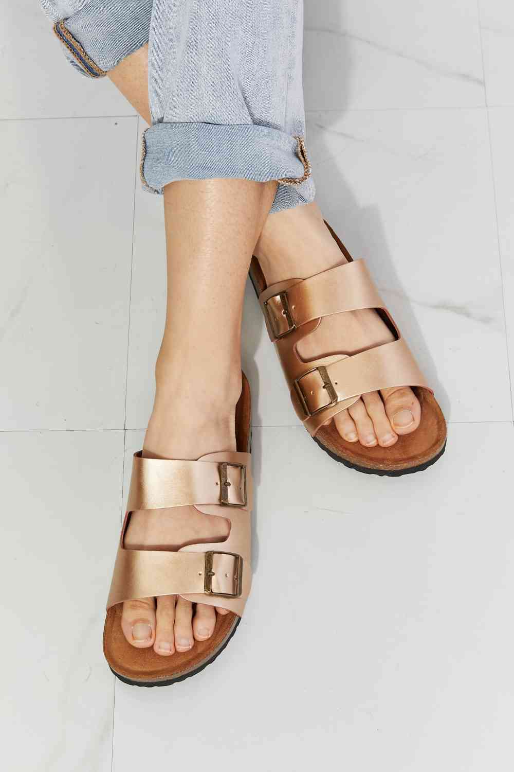 Double-banded slide sandals give a luxe look with their faux leather upper and cork sole. Their comfy design is perfect for wearing for almost any summer adventure. 