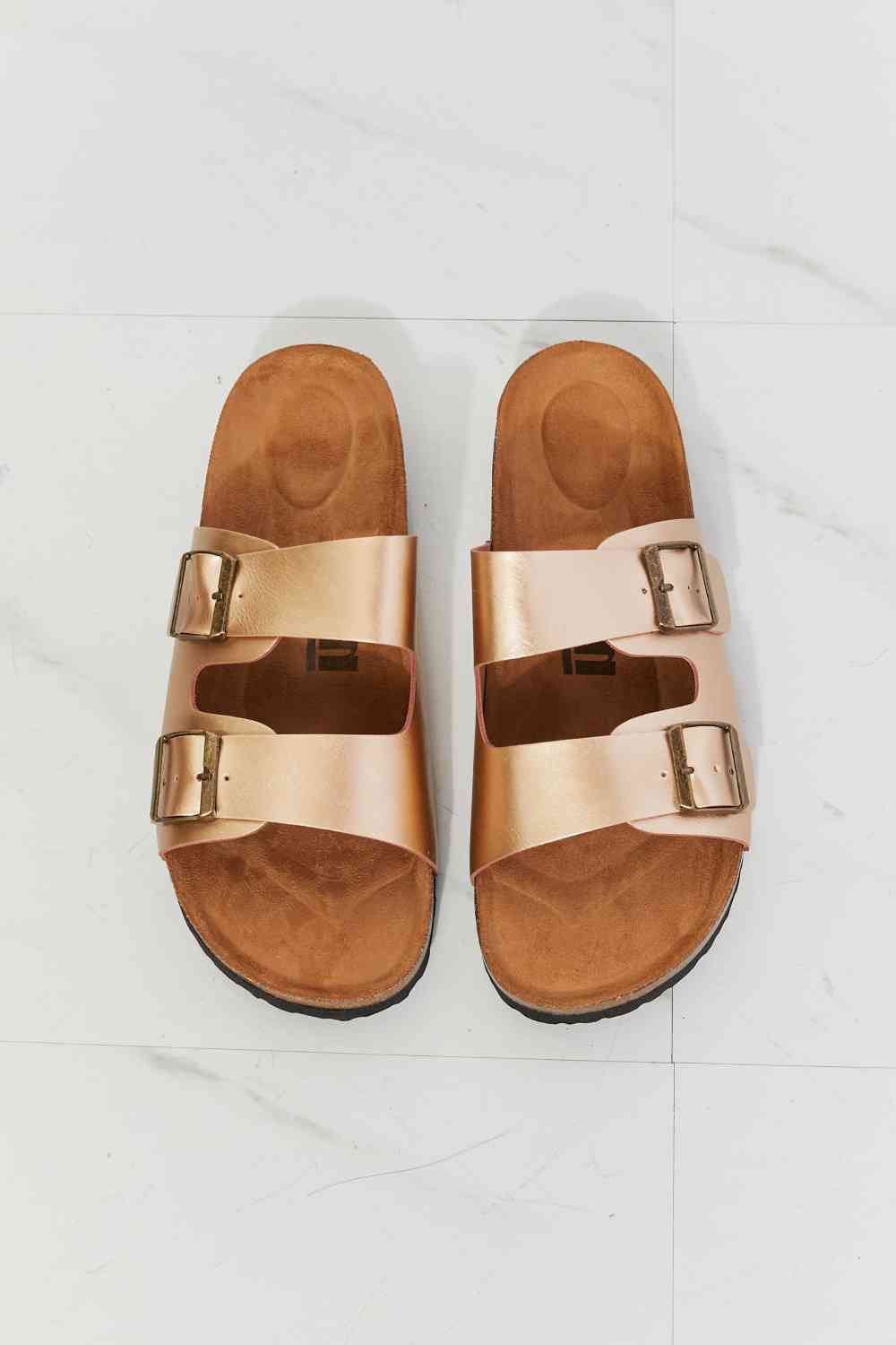 Double-banded slide sandals give a luxe look with their faux leather upper and cork sole. Their comfy design is perfect for wearing for almost any summer adventure. 